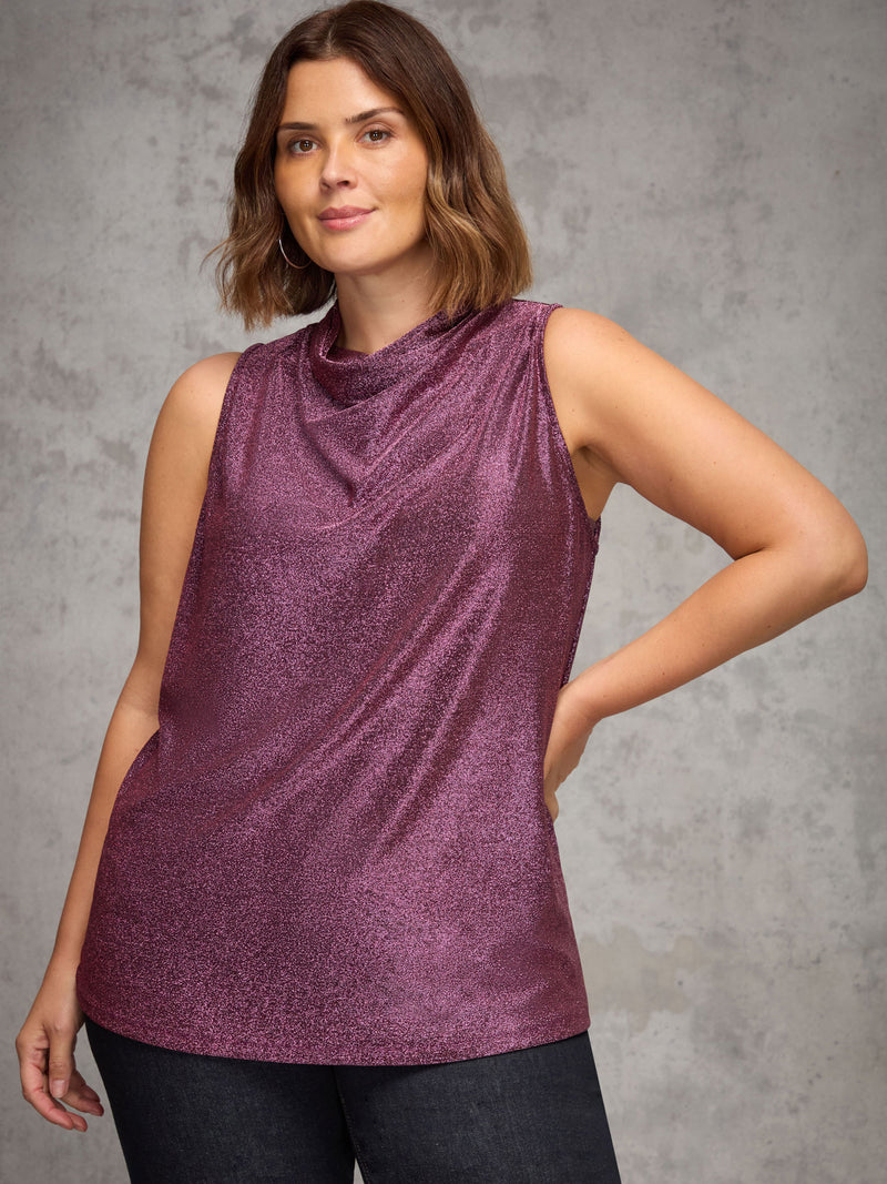 Woman wearing a purple sleeveless top against a gray background