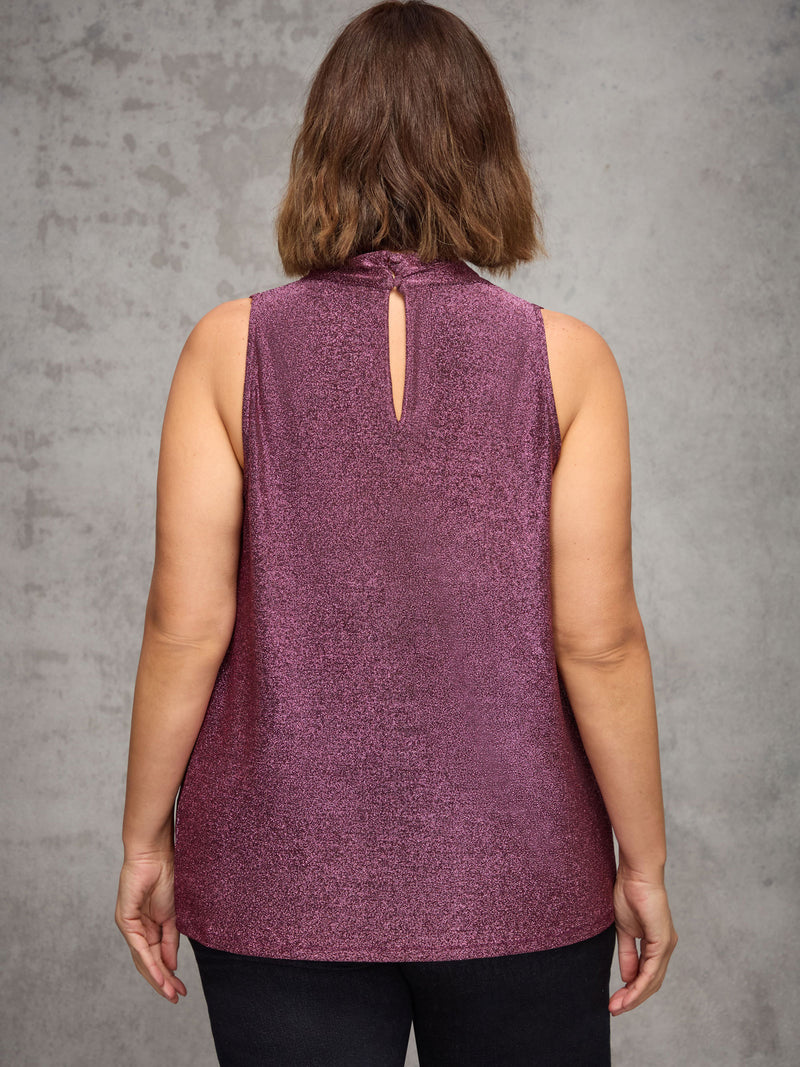 Person wearing a purple sleeveless top with a cut-out back design against a gray background