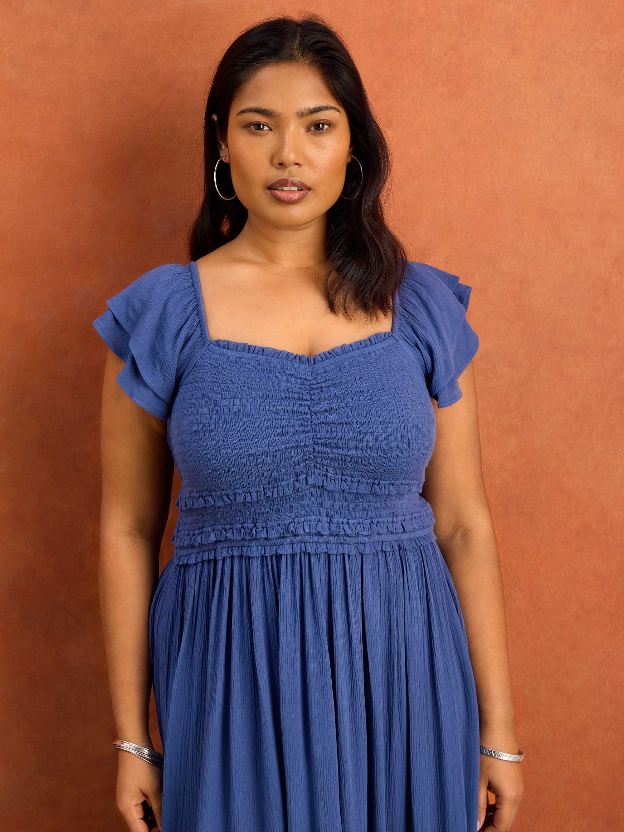 Blue smocked bodice dress with flutter sleeves