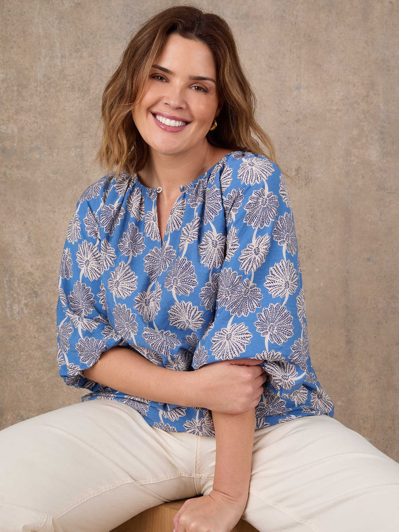 Blue floral blouse with raglan sleeves and relaxed fit