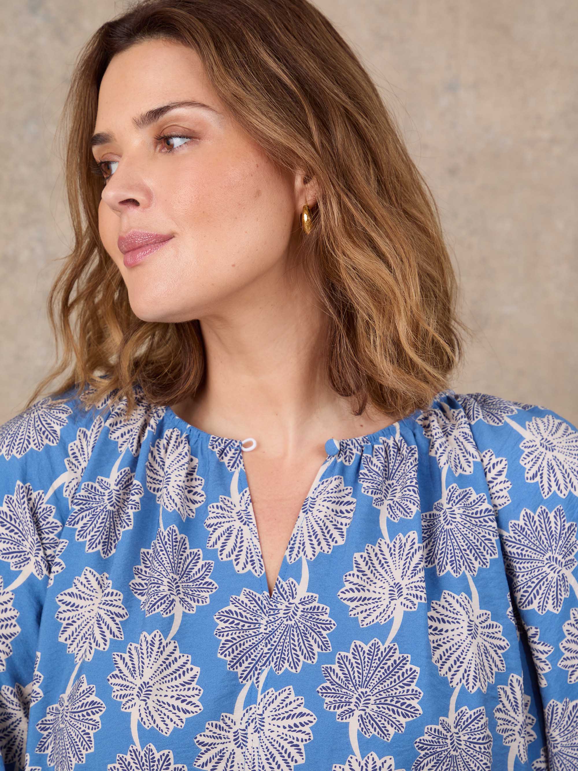Blue and white floral print blouse with puff sleeves