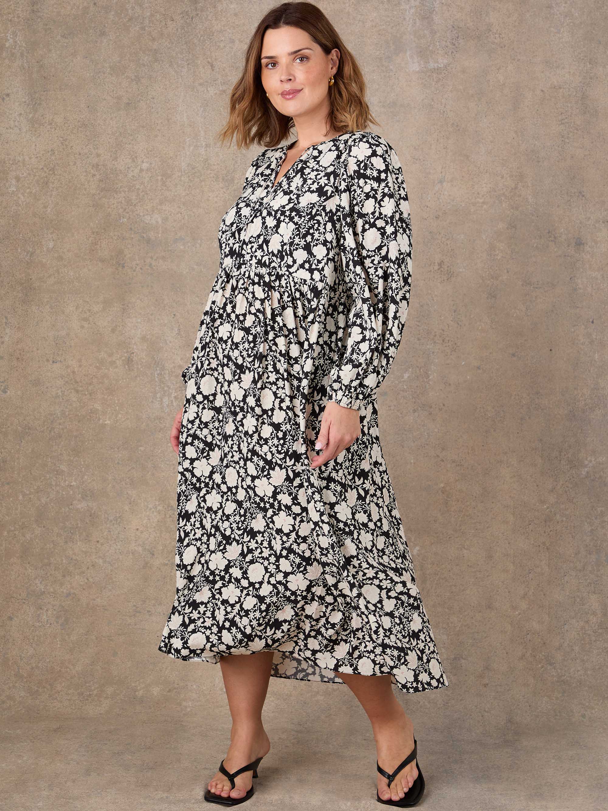 Black floral tie neck dress with flowing silhouette