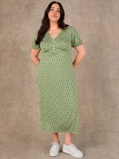 Green ditsy print dress with ruffle V neck and flowing skirt