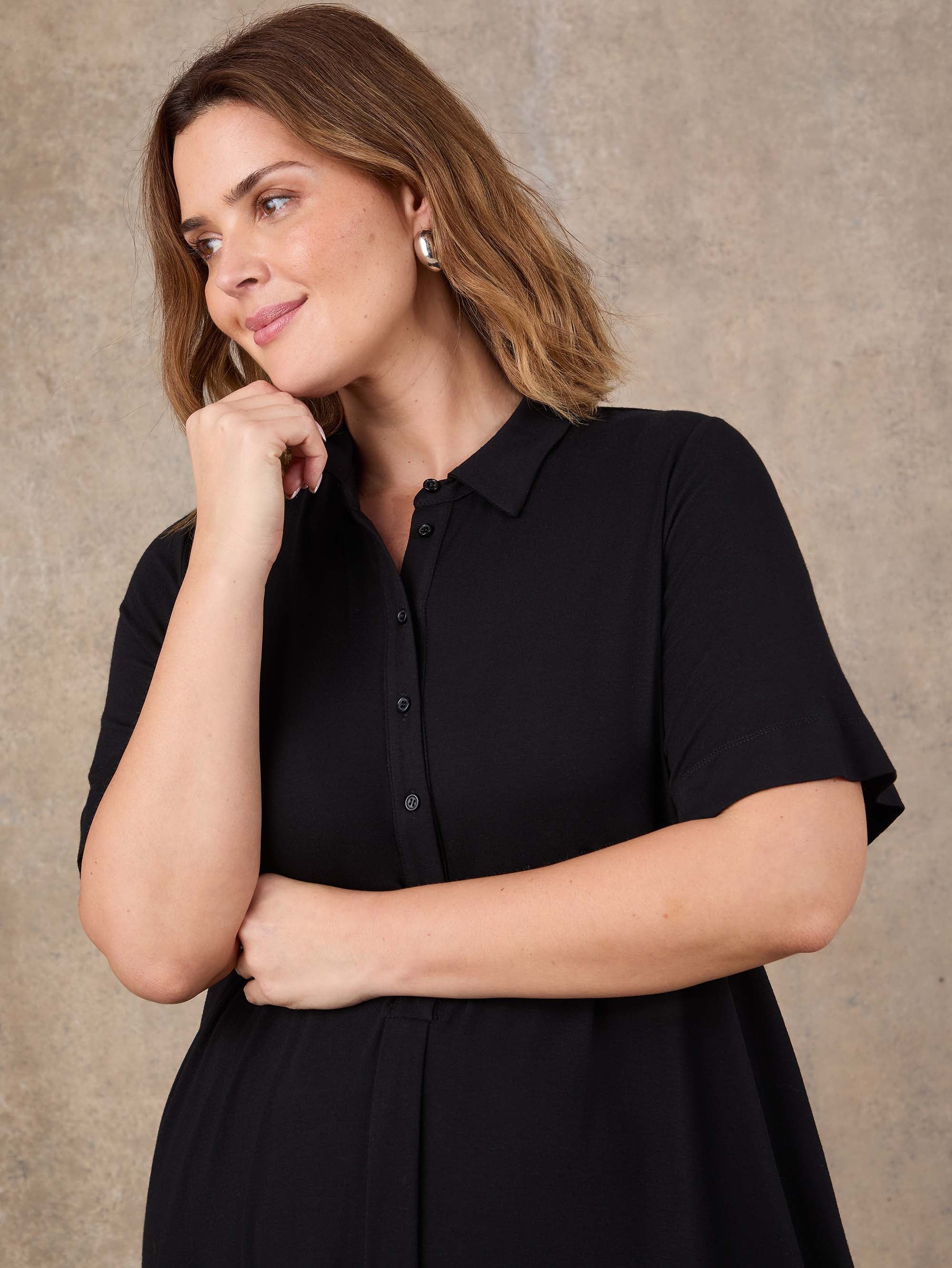 Black collared shirt dress with front pleat and knee length hem