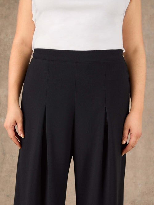 Black high rise tailored trousers with wide leg silhouette