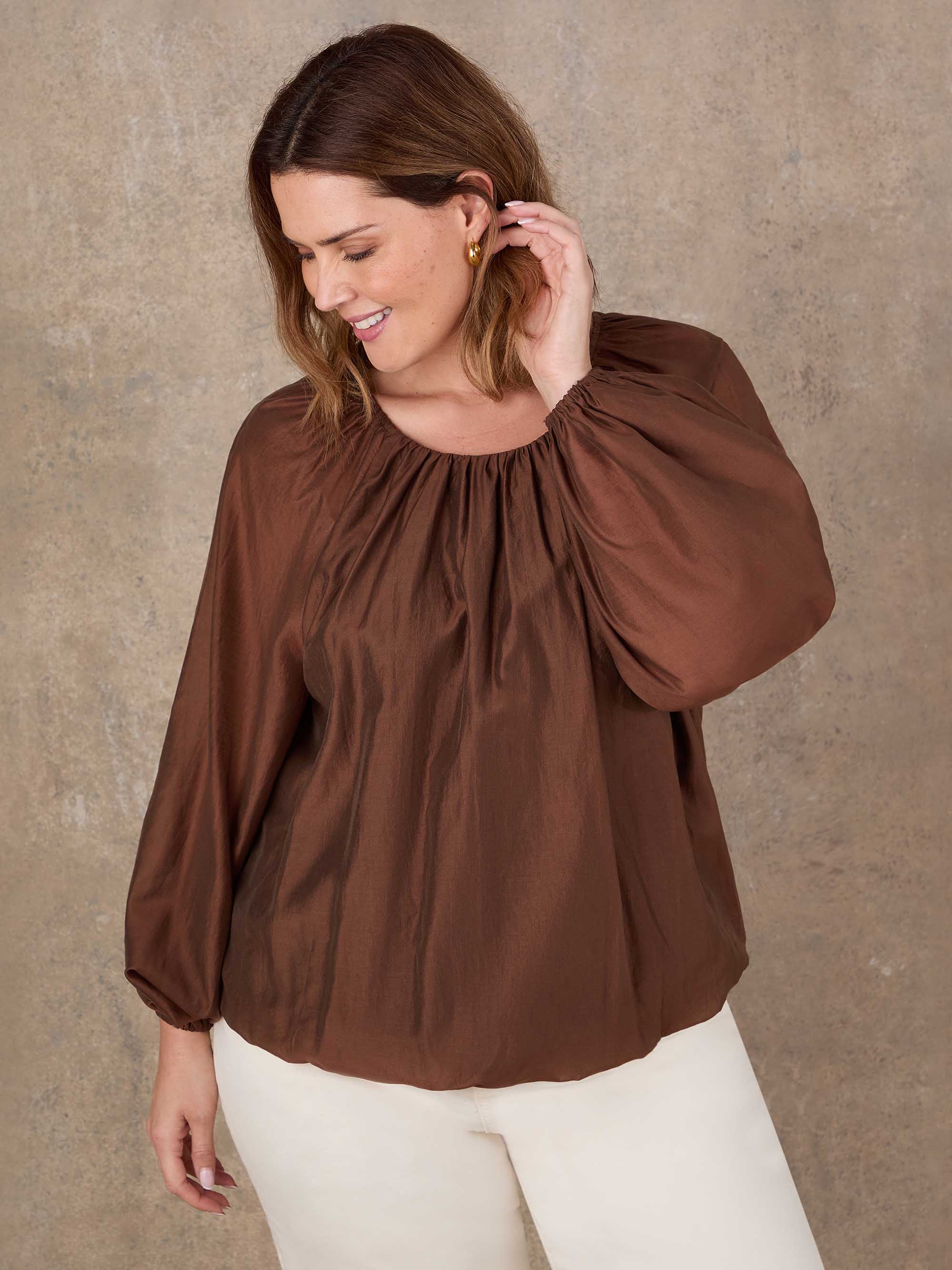 Plus size brown long sleeve boho top with elastic cuffs and flowing silhouette