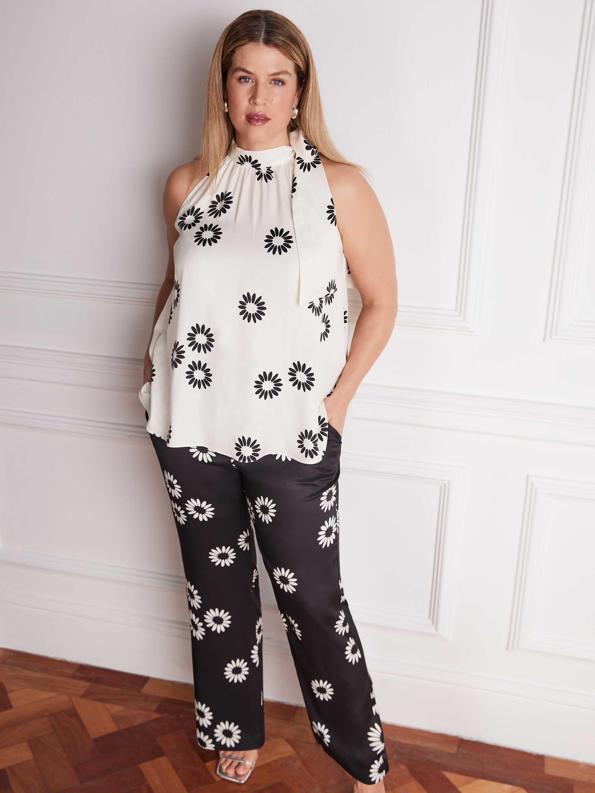 Plus size black floral print trousers front view