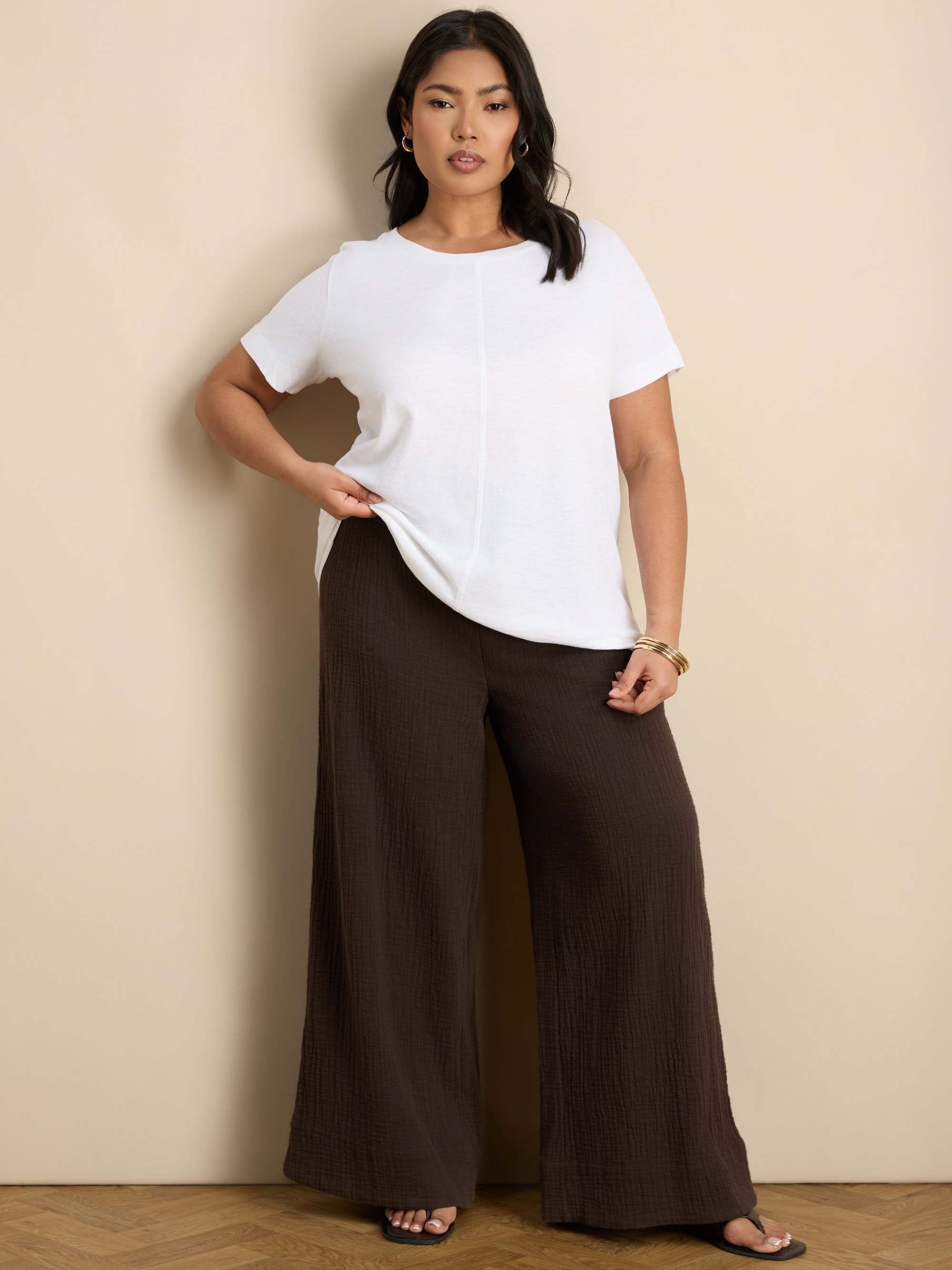 Plus size chocolate wide leg trousers featuring a flat front, gathered waist and comfortable shirred back waistband.