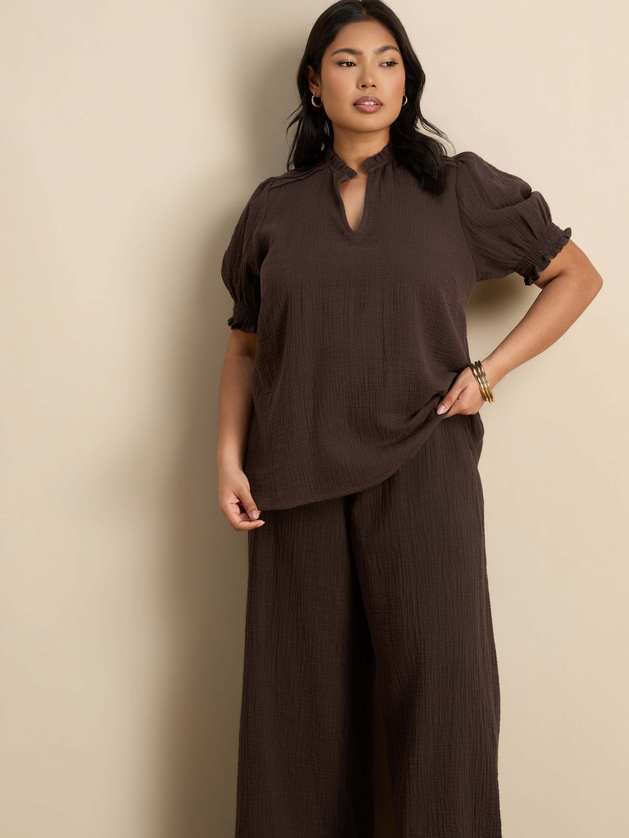 Plus size chocolate wide leg trousers featuring a flat front, gathered waist and comfortable shirred back waistband.