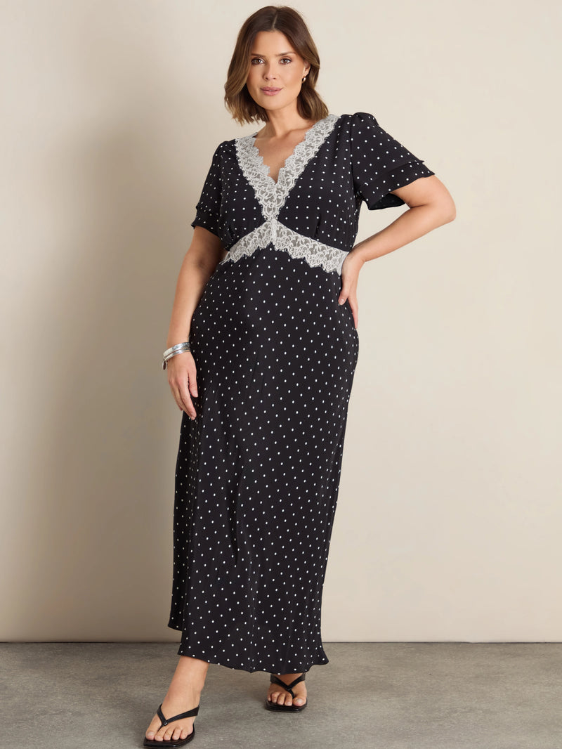 Plus size black polka dot maxi dress with lace trim, flutter sleeves and empire waist