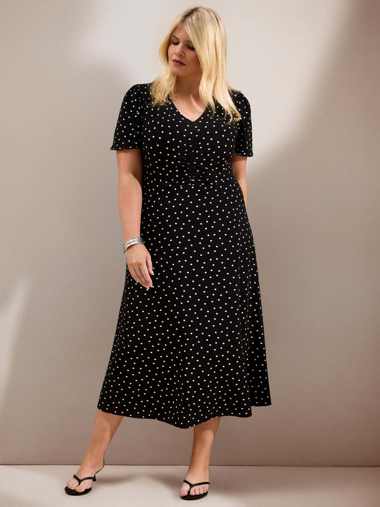 Curve black polka dot jersey midi dress with a defined waist, short flutter sleeves and flowing skirt.