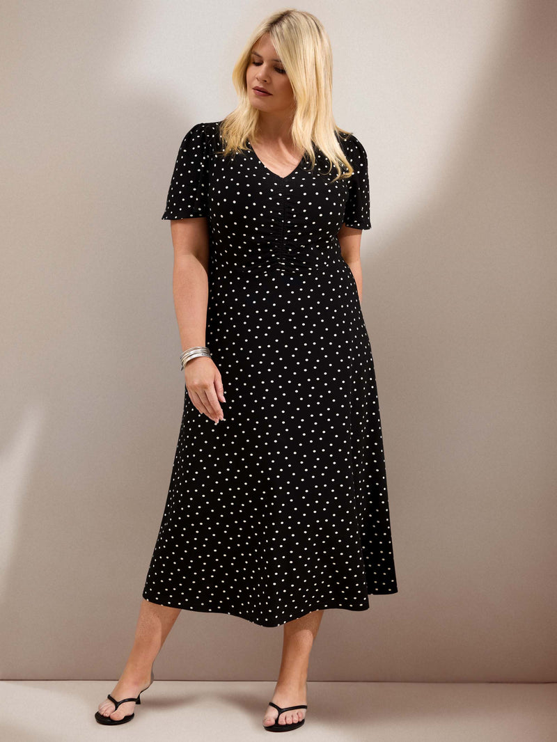 Curve black polka dot jersey midi dress with a defined waist, short flutter sleeves and flowing skirt.