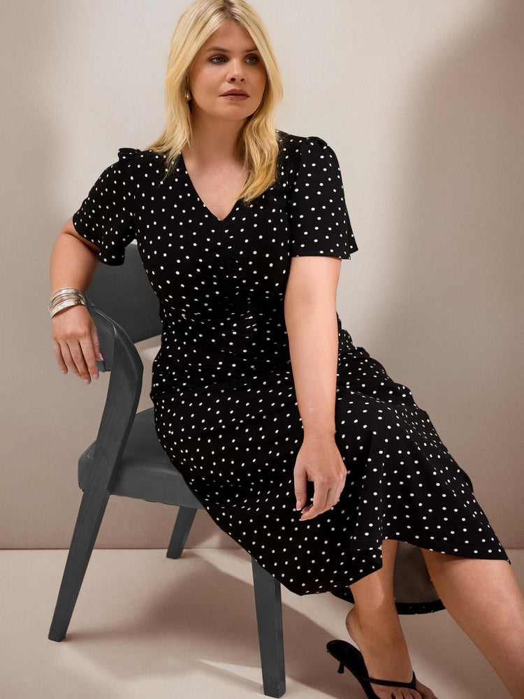 Curve black polka dot jersey midi dress with a defined waist, short flutter sleeves and flowing skirt.