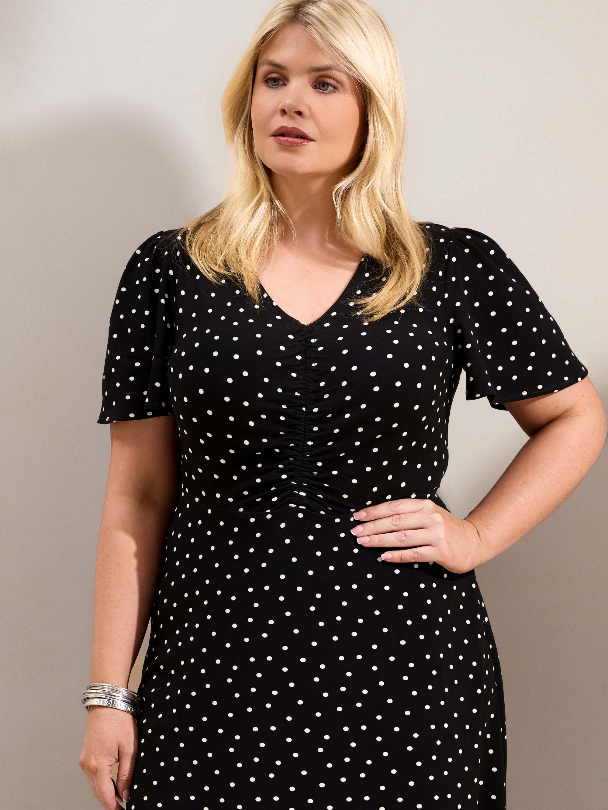 Curve black polka dot jersey midi dress with a defined waist, short flutter sleeves and flowing skirt.