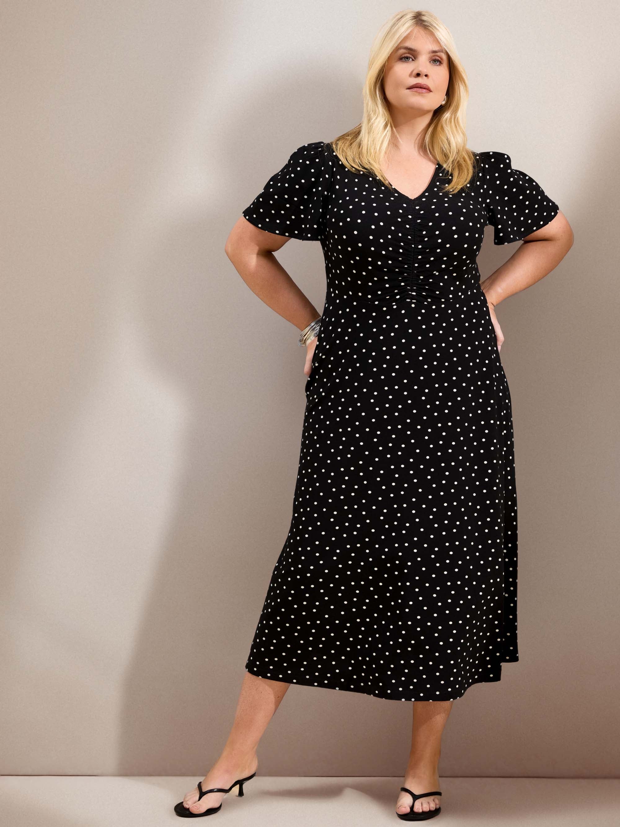 Curve black polka dot jersey midi dress with a defined waist, short flutter sleeves and flowing skirt.