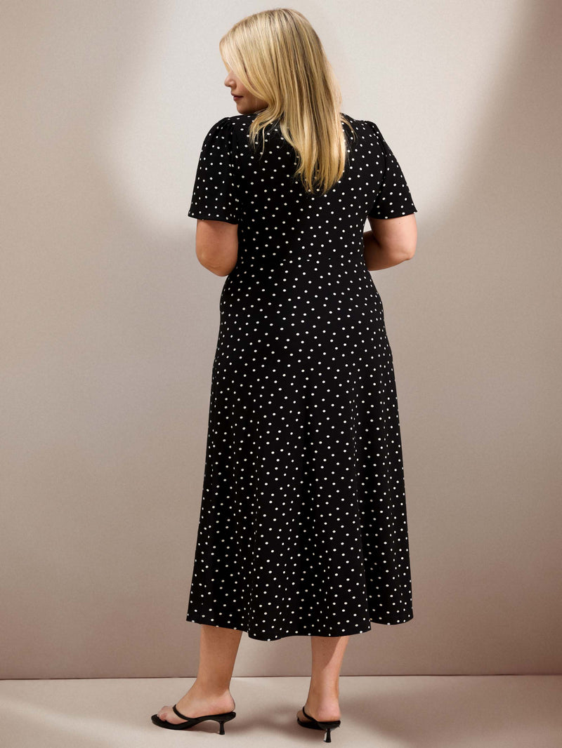 Curve black polka dot jersey midi dress with a defined waist, short flutter sleeves and flowing skirt.
