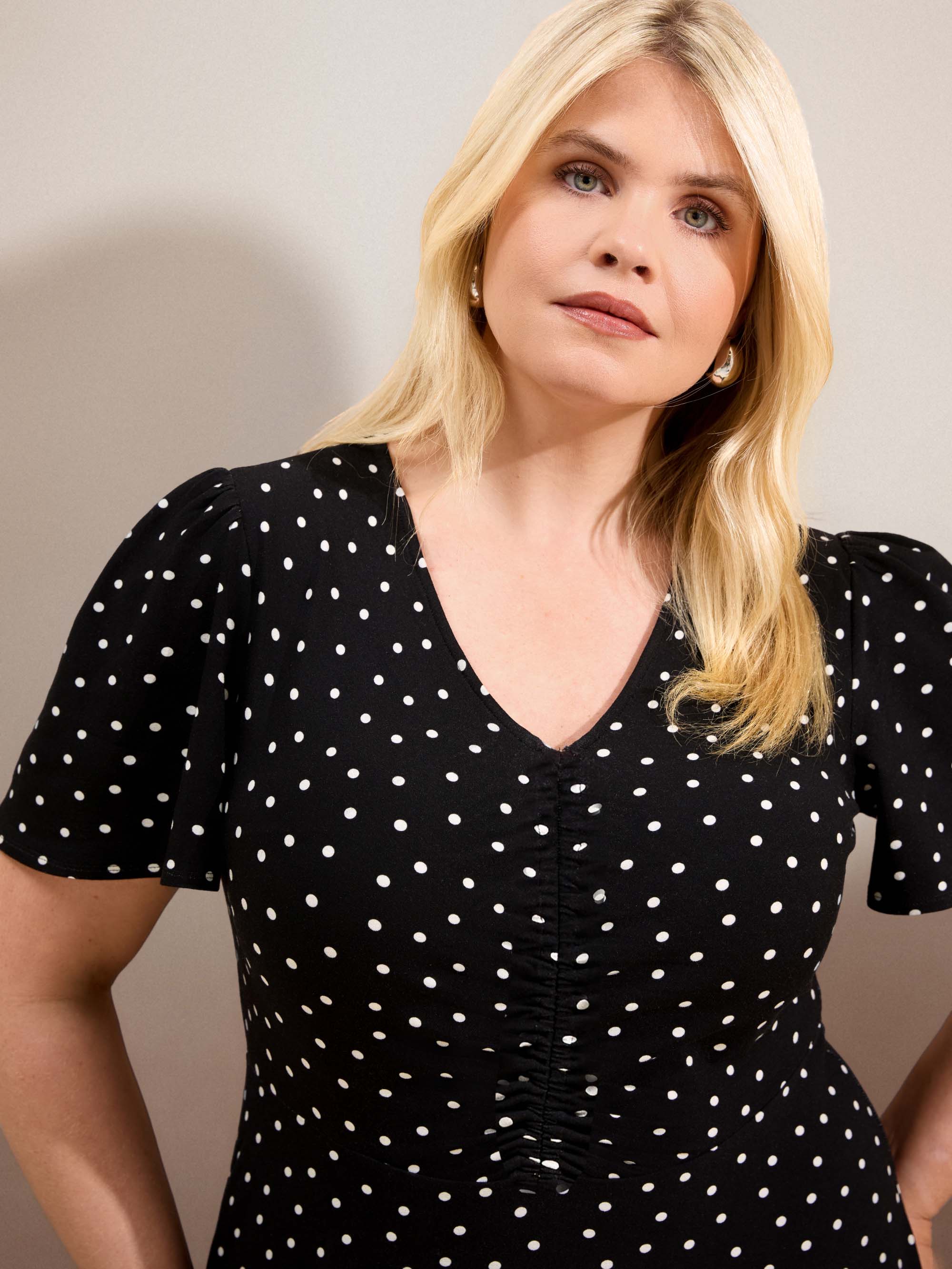 Curve black polka dot jersey midi dress with a defined waist, short flutter sleeves and flowing skirt.