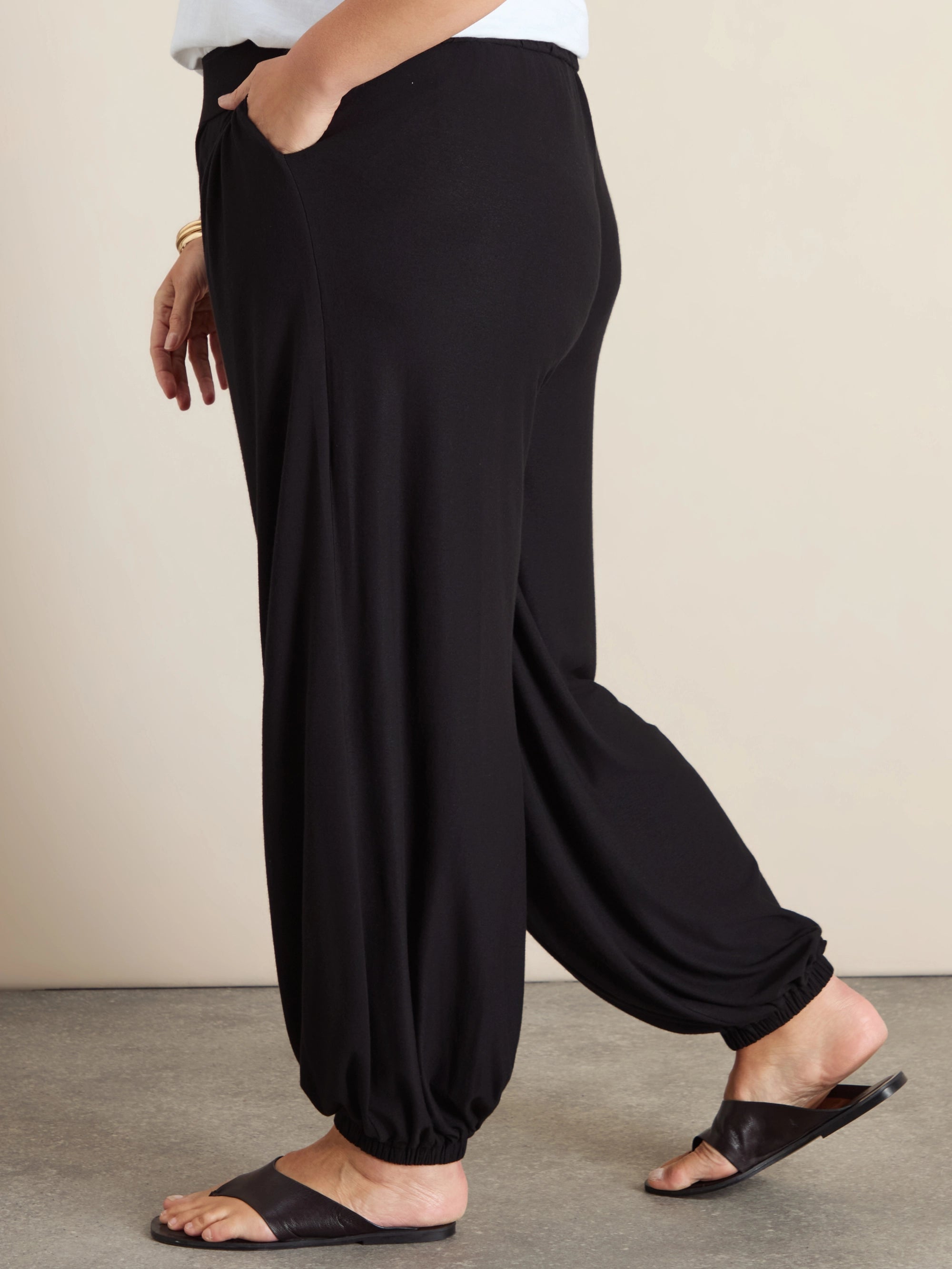 Plus size black jersey balloon leg trousers with elasticated cuffs and pockets
