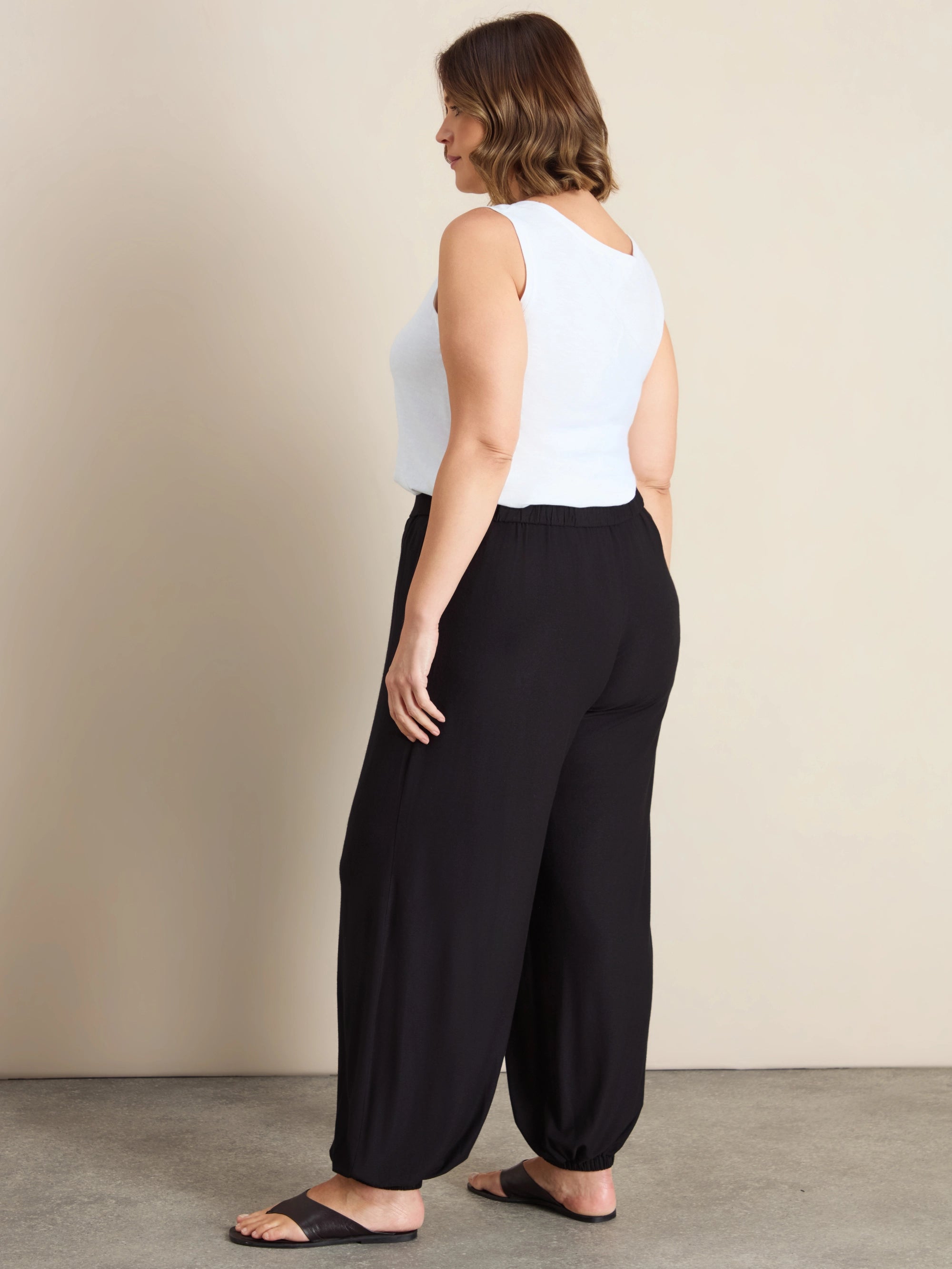 Plus size black jersey balloon leg trousers with elasticated cuffs and pockets