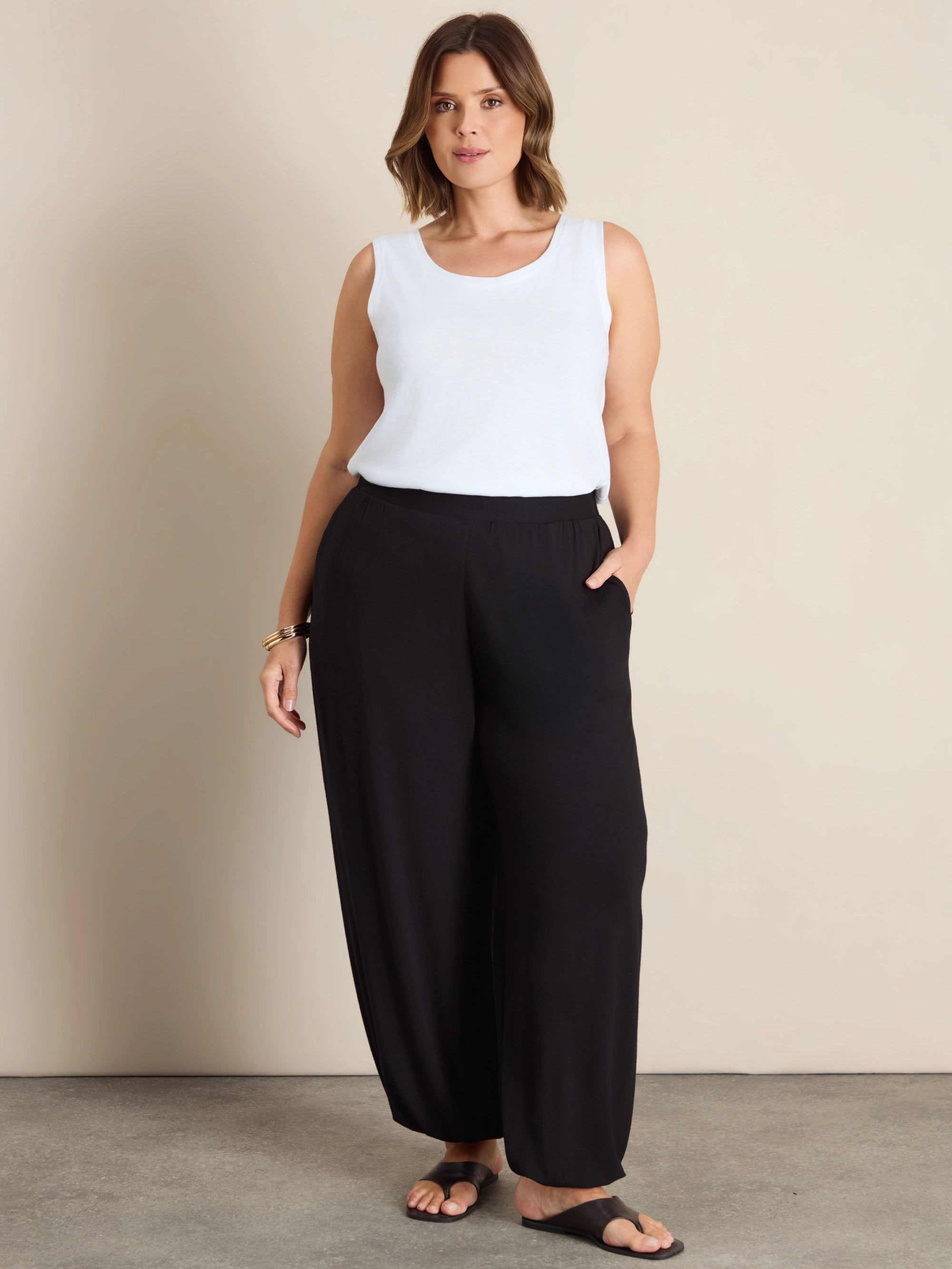 Plus size black jersey balloon leg trousers with elasticated cuffs and pockets