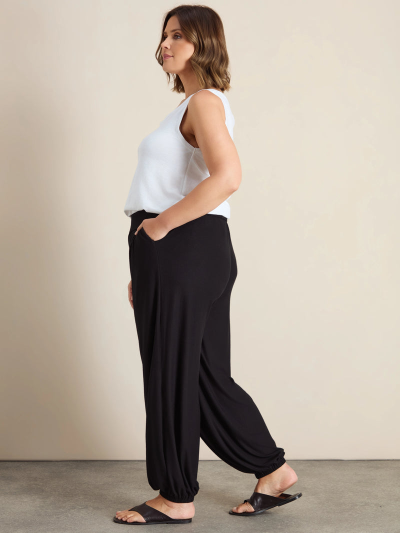 Plus size black jersey balloon leg trousers with elasticated cuffs and pockets