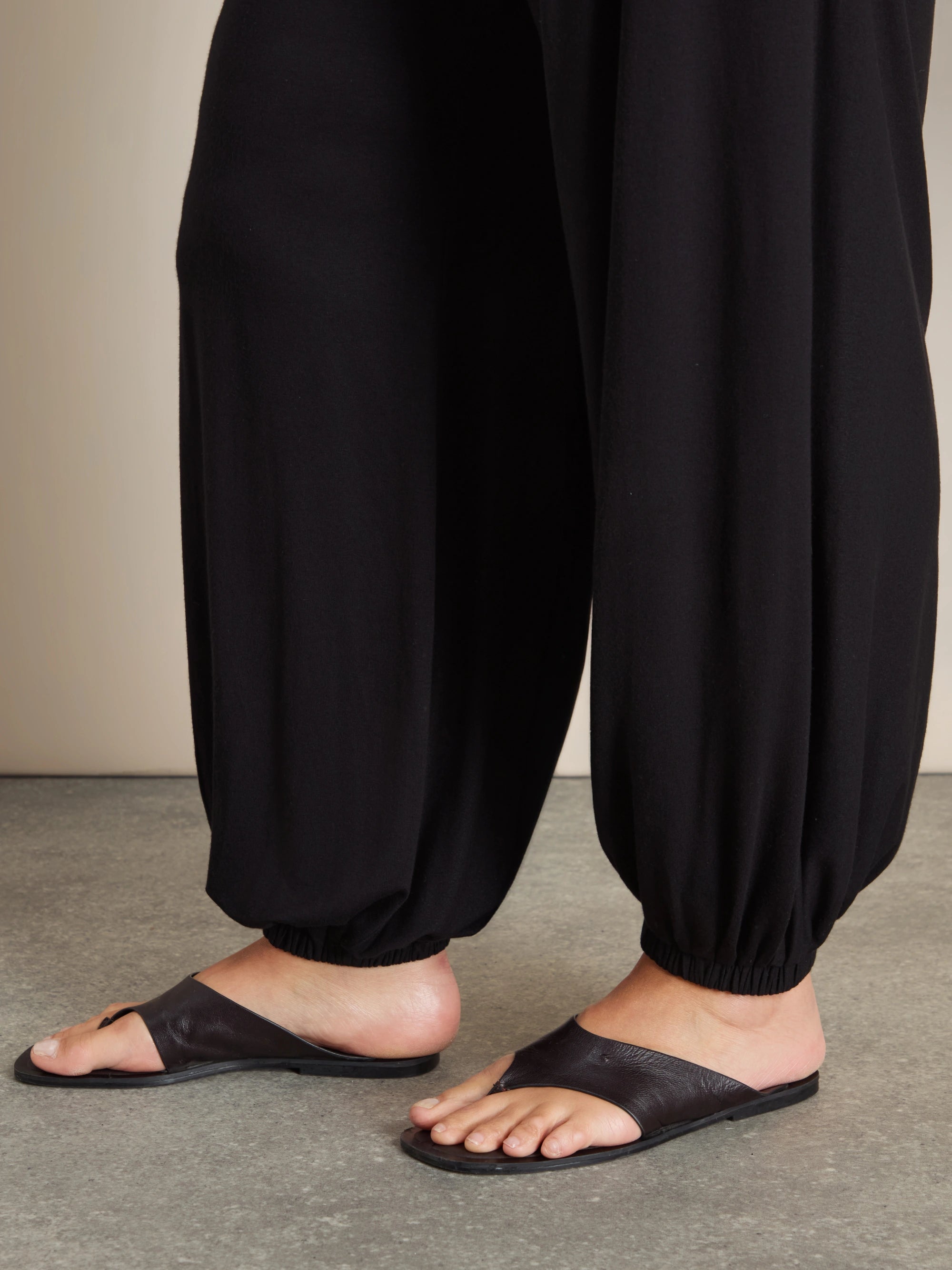 Plus size black jersey balloon leg trousers with elasticated cuffs and pockets