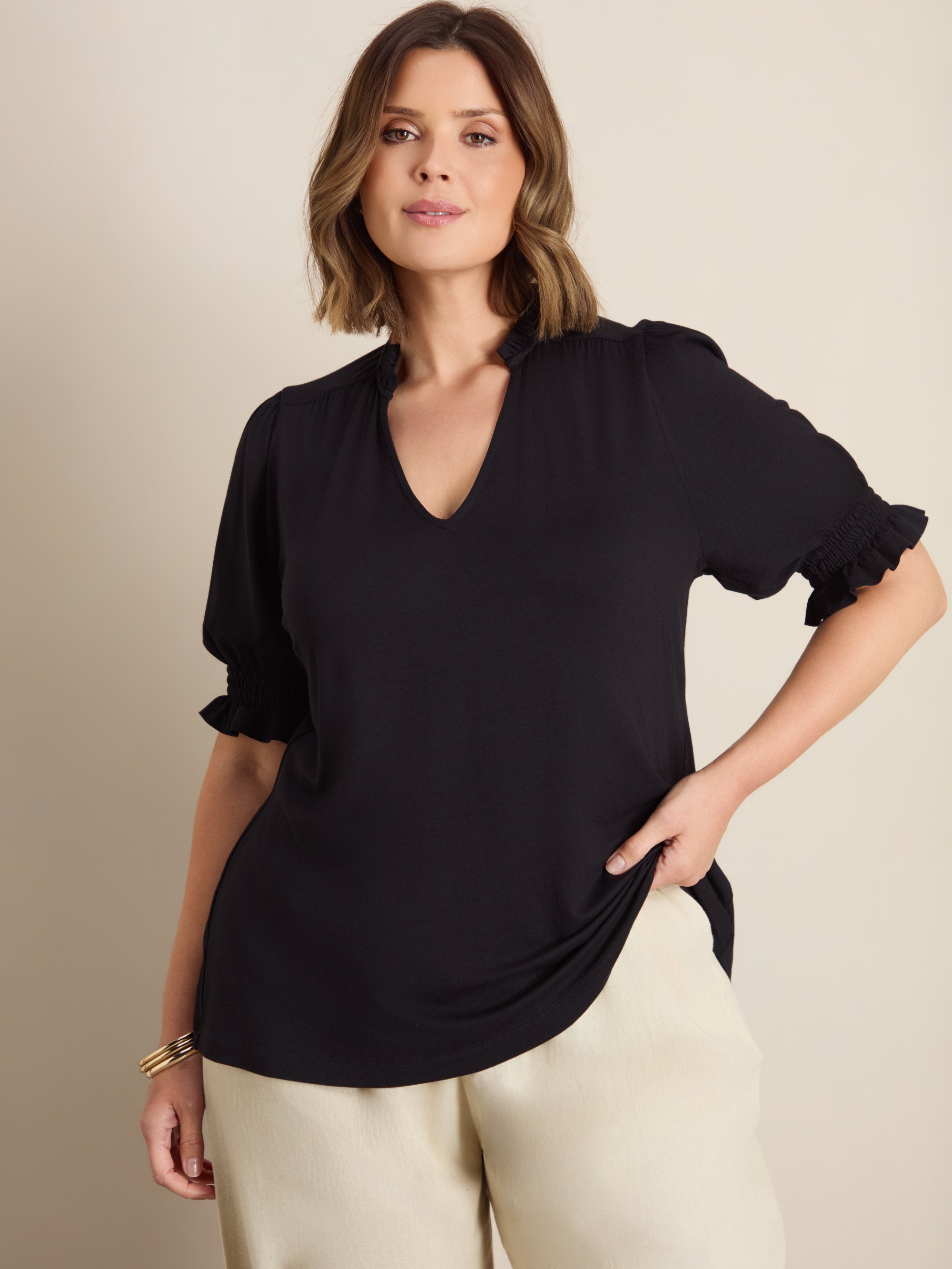 Plus size blouse with ruffle neckline, puff sleeves and gathered yoke detail