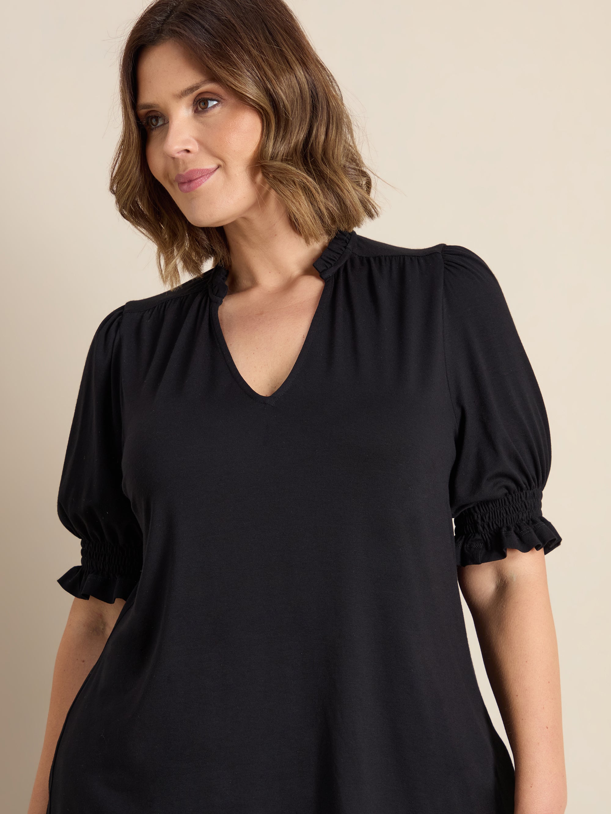 Plus size blouse with ruffle neckline, puff sleeves and gathered yoke detail