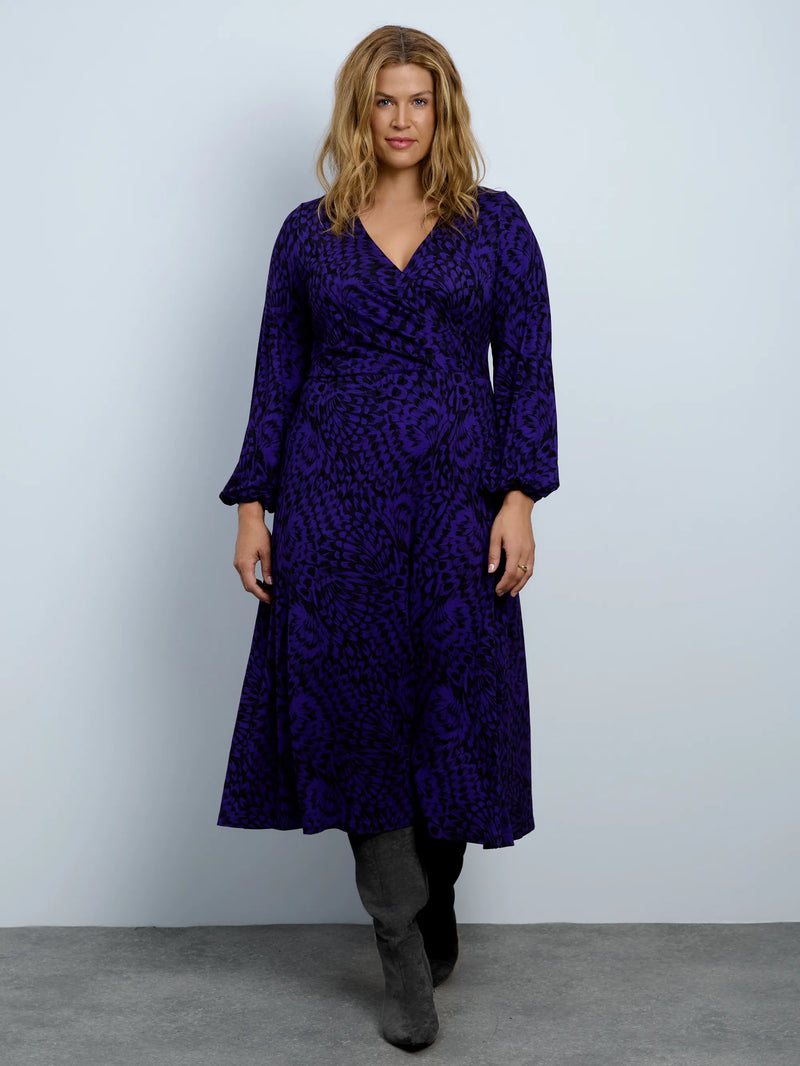 Purple abstract print jersey wrap midi dress with long sleeves.