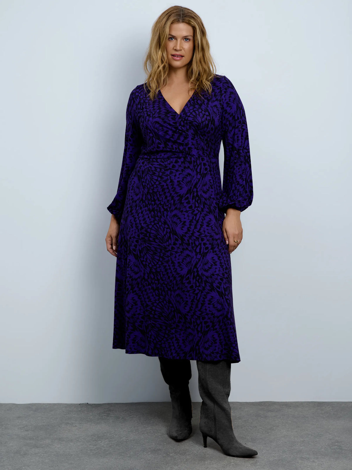 Purple abstract print jersey wrap midi dress with long sleeves.