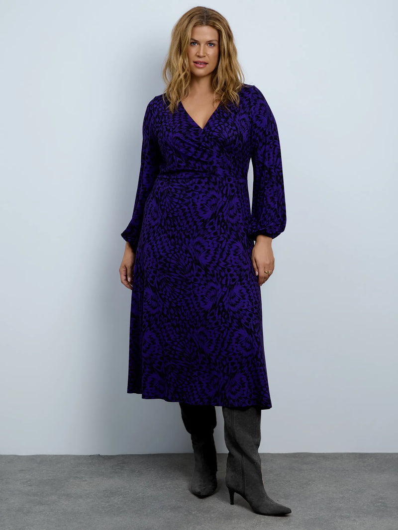 Purple abstract print jersey wrap midi dress with long sleeves.