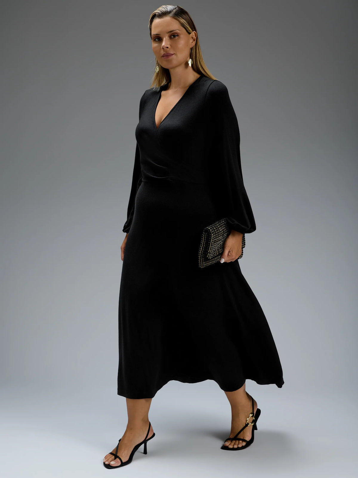 Black jersey wrap midi dress with long sleeves.