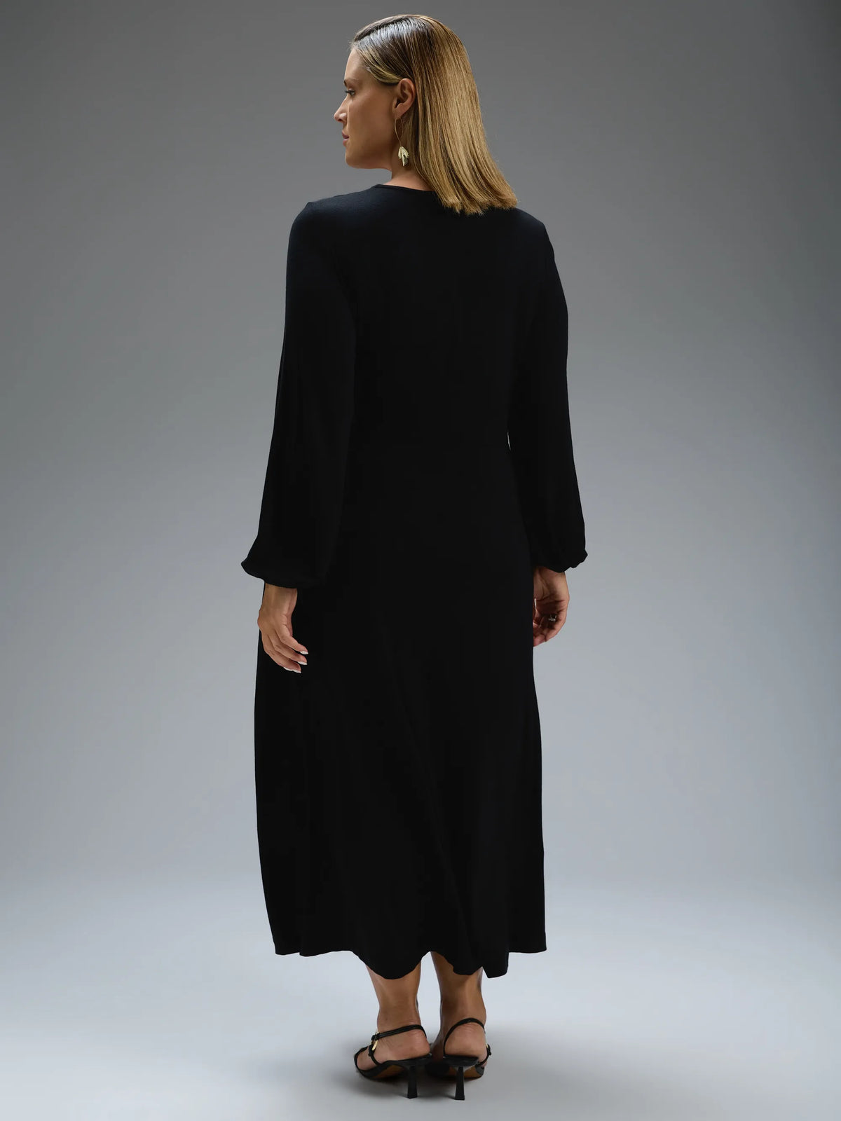 Black jersey wrap midi dress with long sleeves.